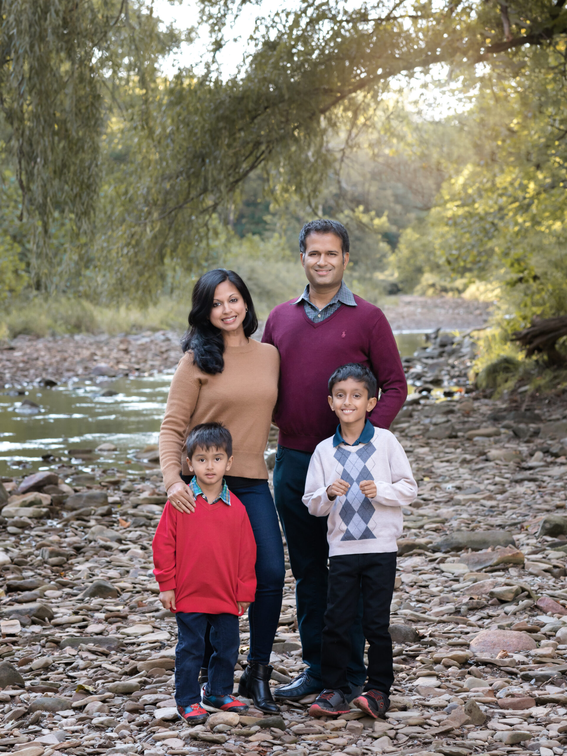 Mom, Dad and two sons taking fall family photos in brecksville reservation
