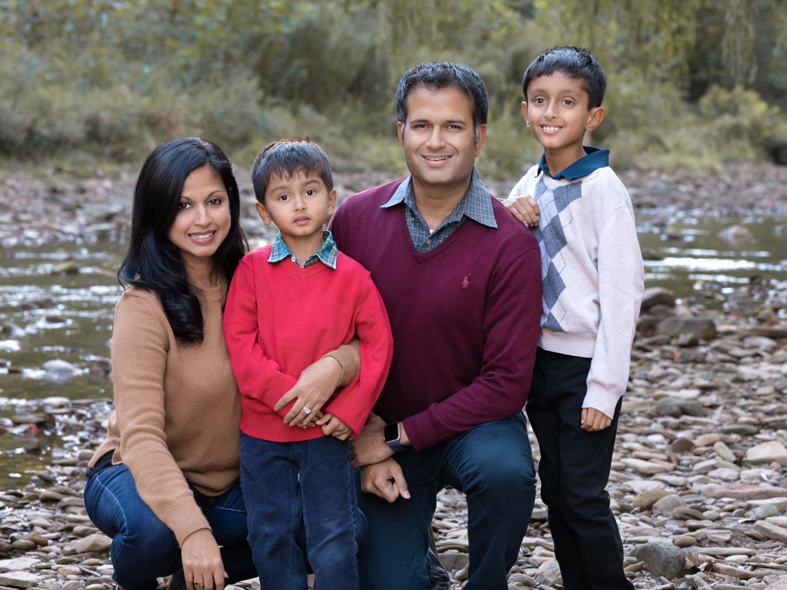 Mom, Dad and two sons taking fall family photos in brecksville reservation