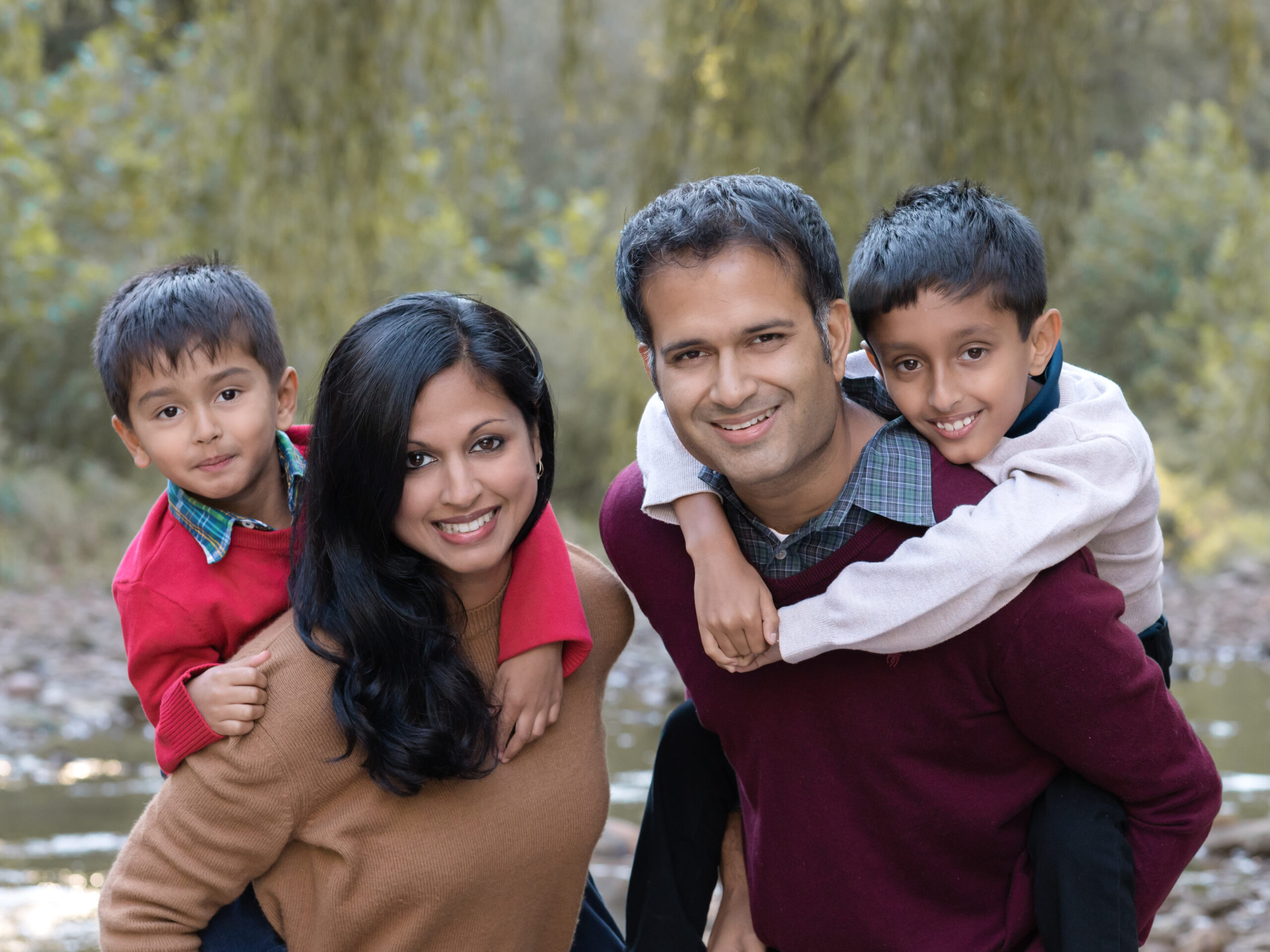 Mom, Dad and two sons taking fall family photos in brecksville reservation
