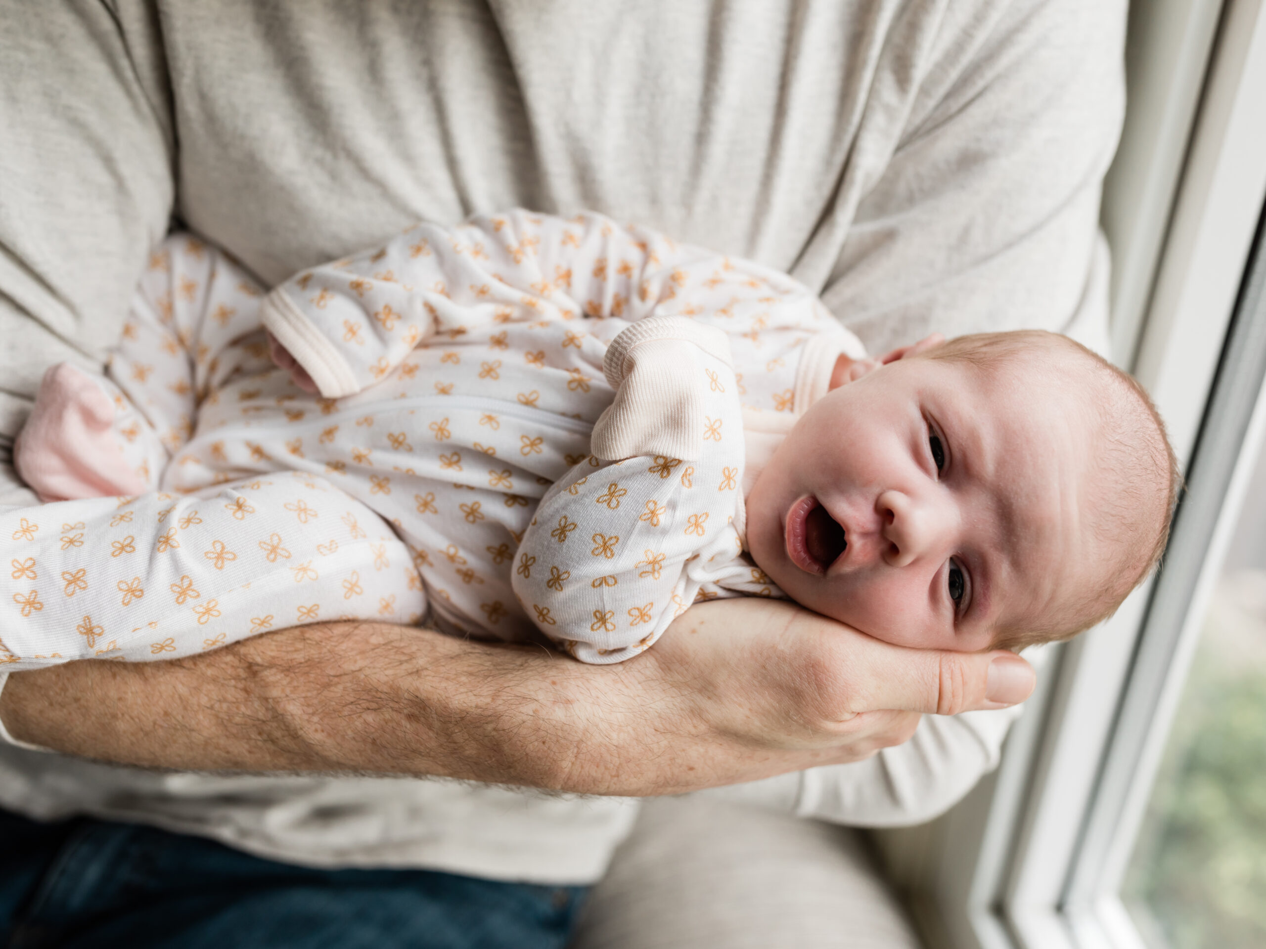 mom and dad holding newborn baby