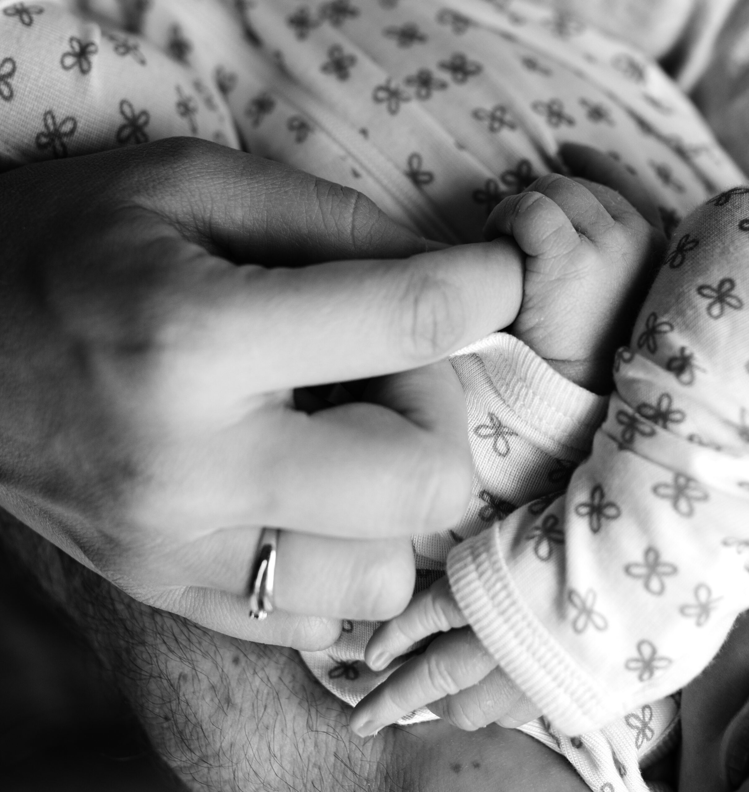 mom and dad holding newborn baby