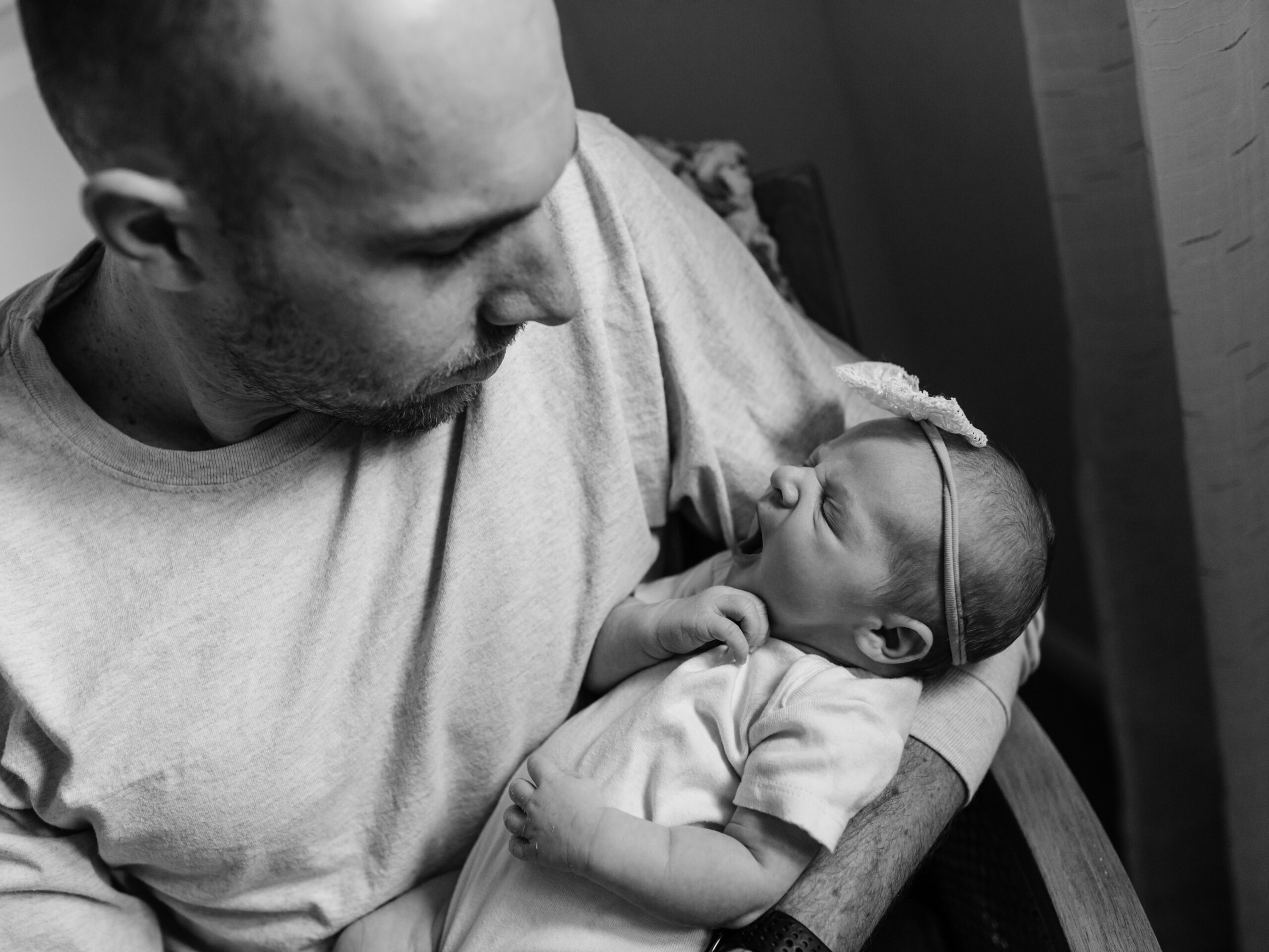 dad holding newborn baby girl