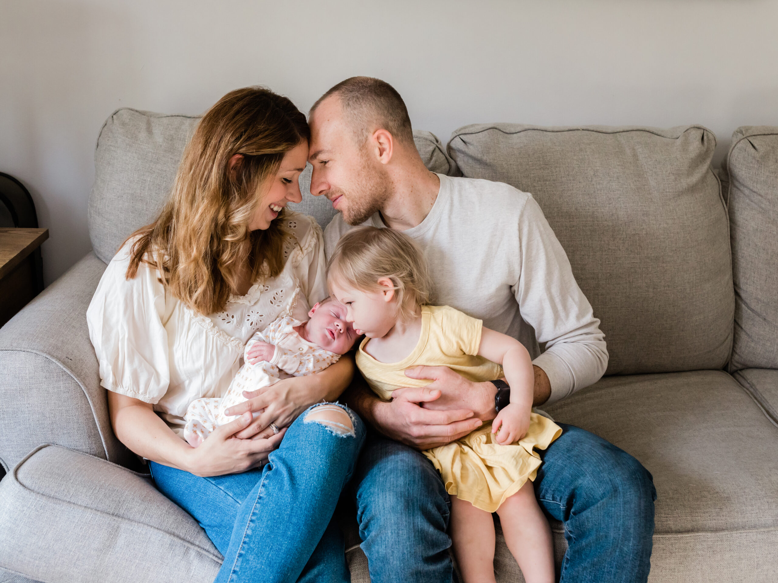 mom, dad, holding newborn baby girl and sister