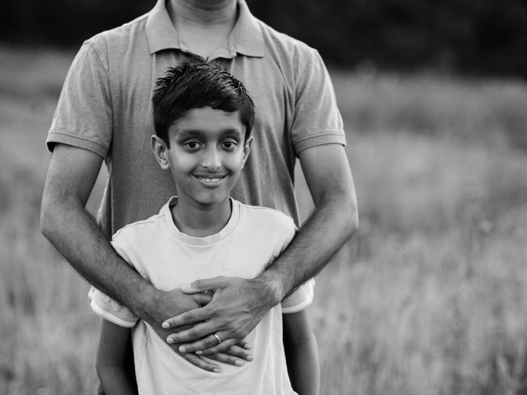 father holding son for family photos