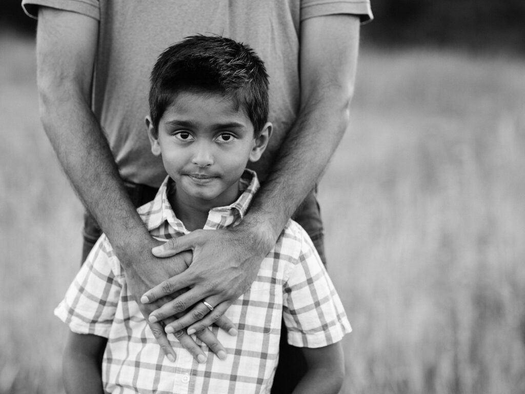 father holding son for family photos