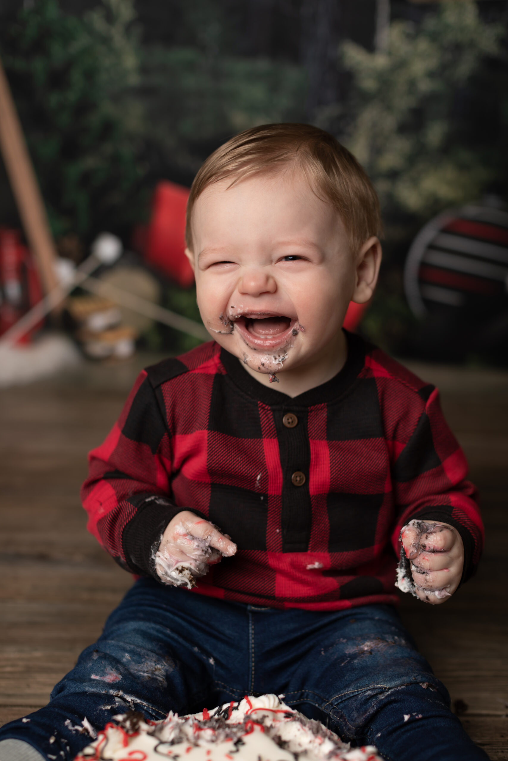 boy laughing at his cake smash session
