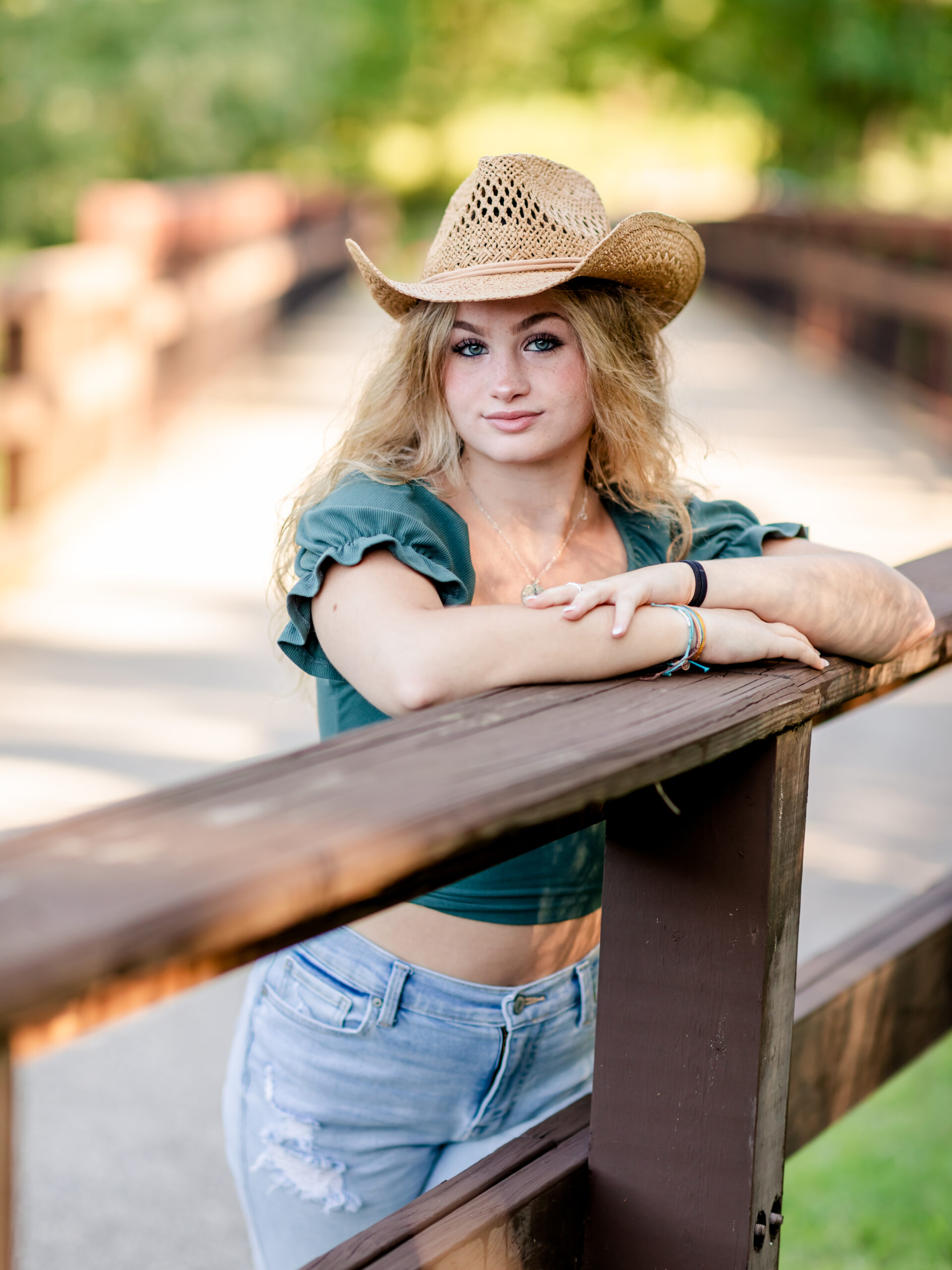 senior girl in cowboy hat at the park