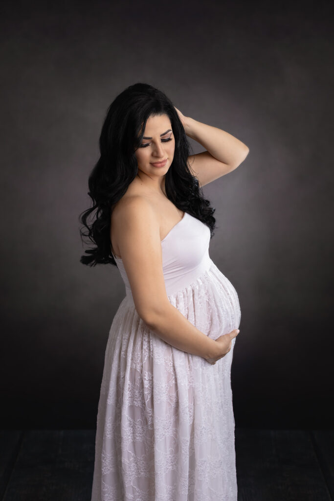 mom to be in lavender maternity gown with her hand in her hair prenatal yoga Cleveland