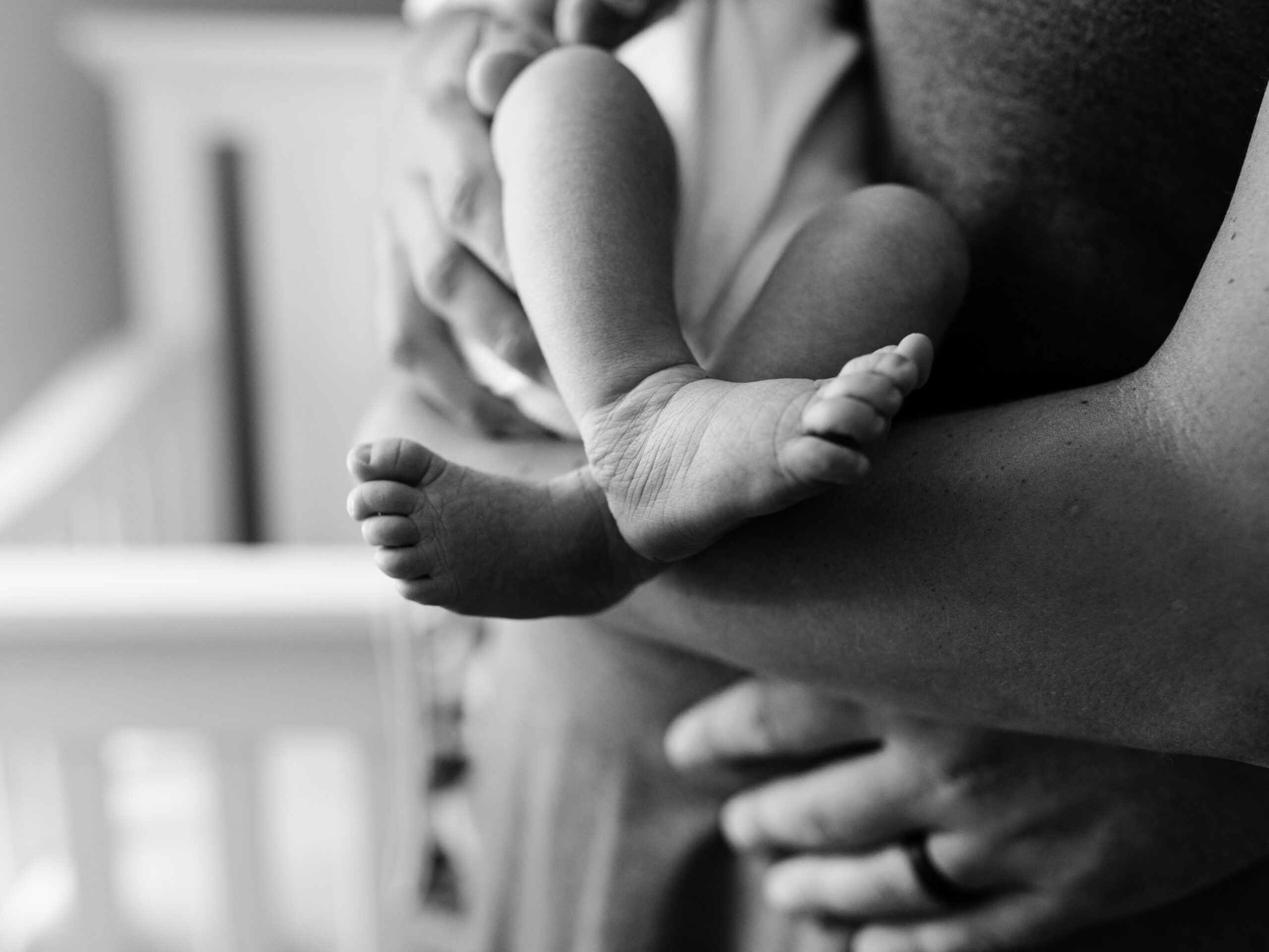 black and white photo of newborn baby feet