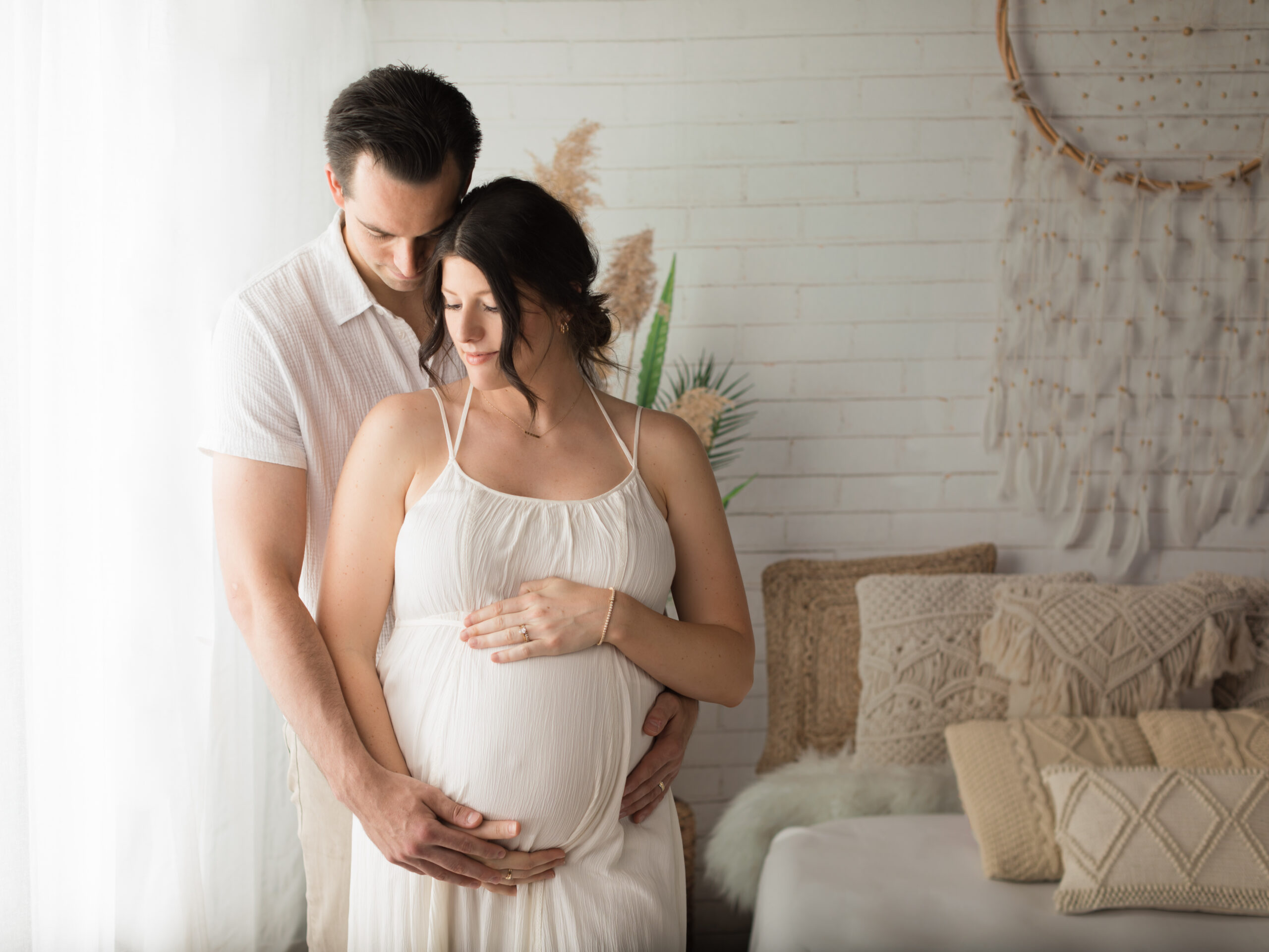 Husband and wife holding pregnant belly for photoshoot Richfield Chiropracter-akron maternity photographer