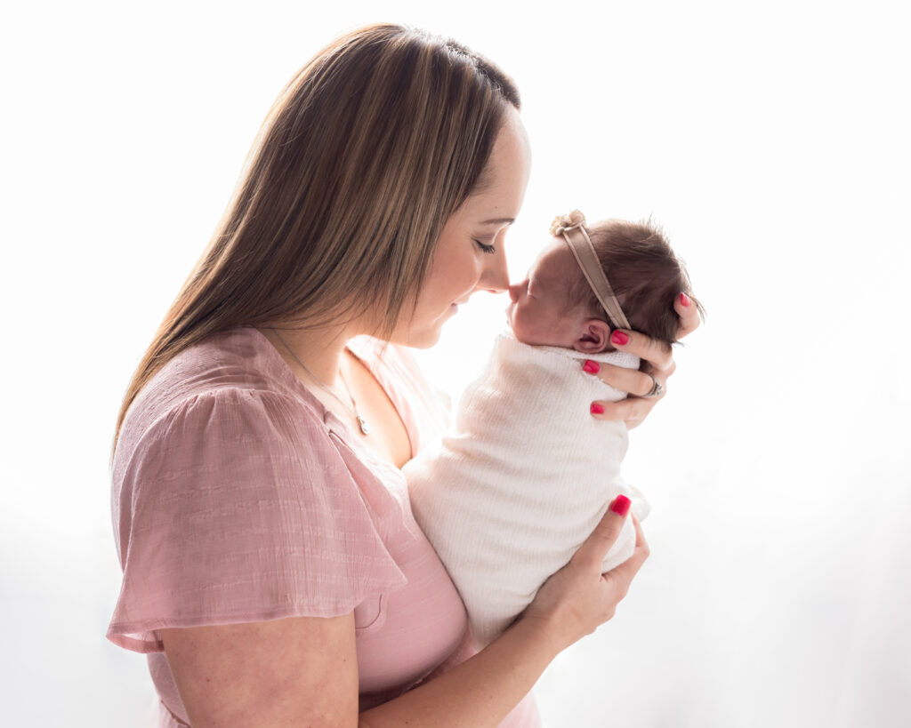 mom touching baby's nose for newborn photoshoot