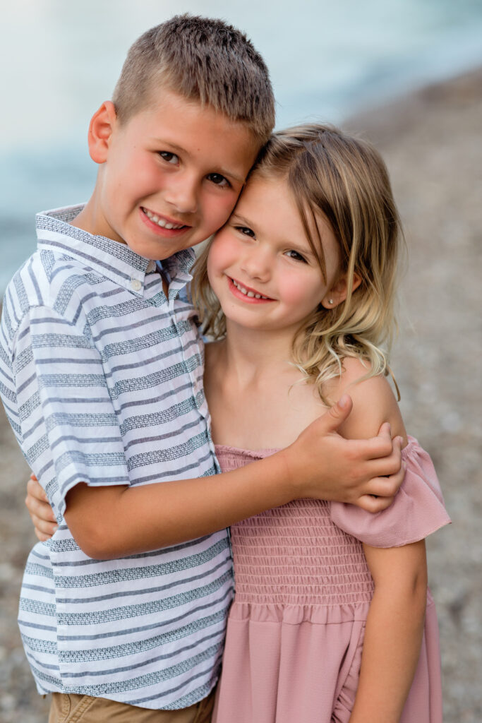 siblings hugging for family portraits Huntington Beach Bay Village