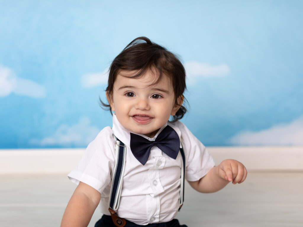one year old boy smiling for photoshoot