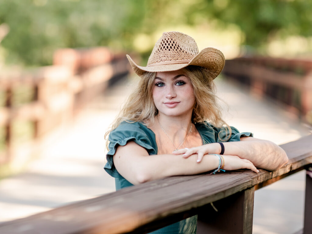 girl posing with cowboy hat for senior portraits westcreek reservation