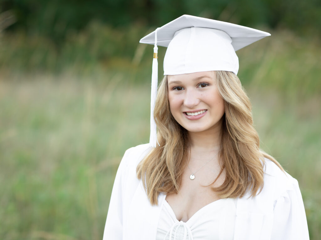 girl in cap and gown for graduation photos at westcreek reservation