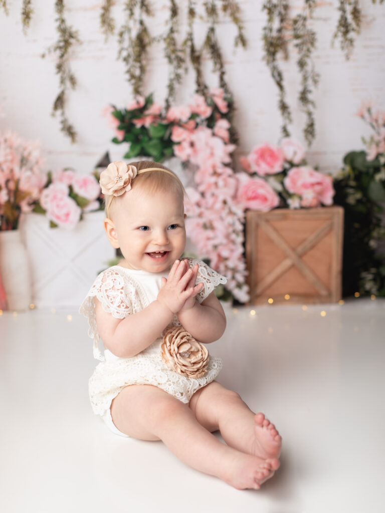 one year old dressed in lace romper for first birthday 
