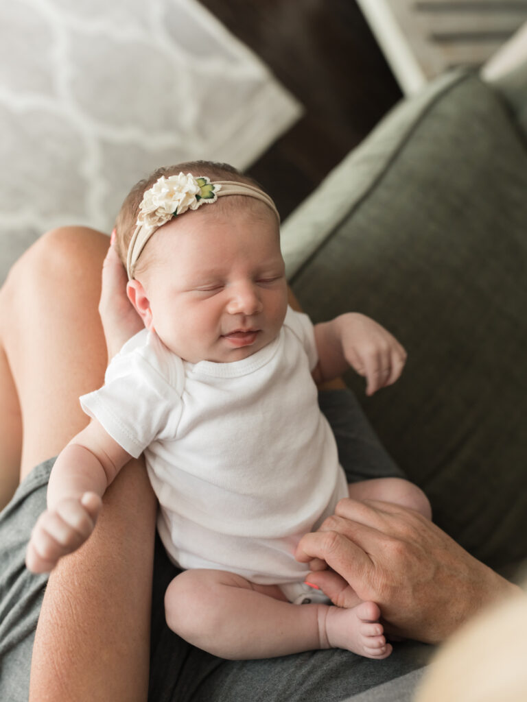 newborn baby girl in moms lap for photo session