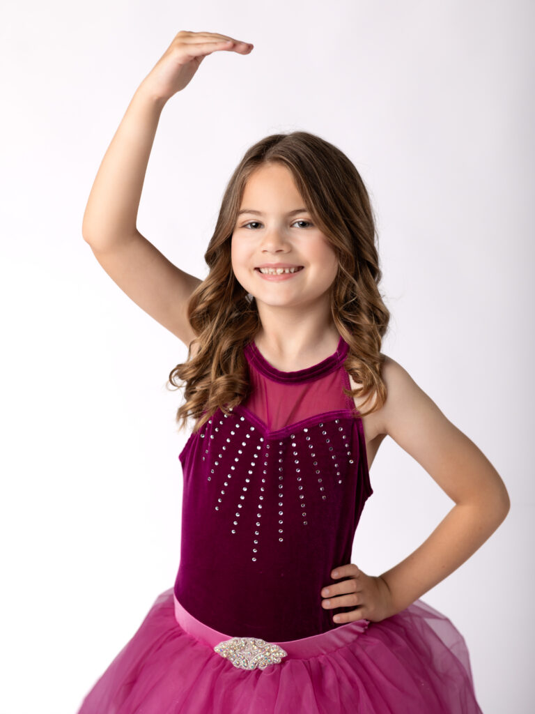 girl in pink dance costume posing for dance portraits
