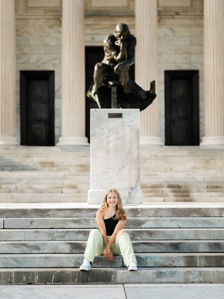 senior girl sitting on steps of cleveland art museum