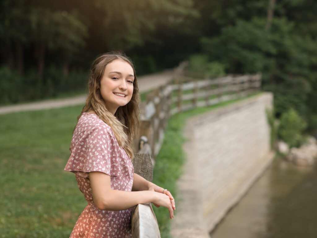 girl posing by chagrin river park for senior portraits