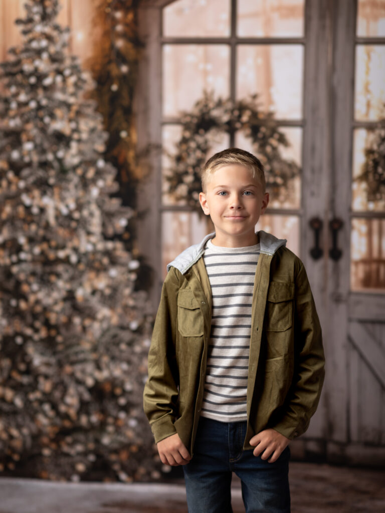 boy in green hoodie posed for Christmas portraits 