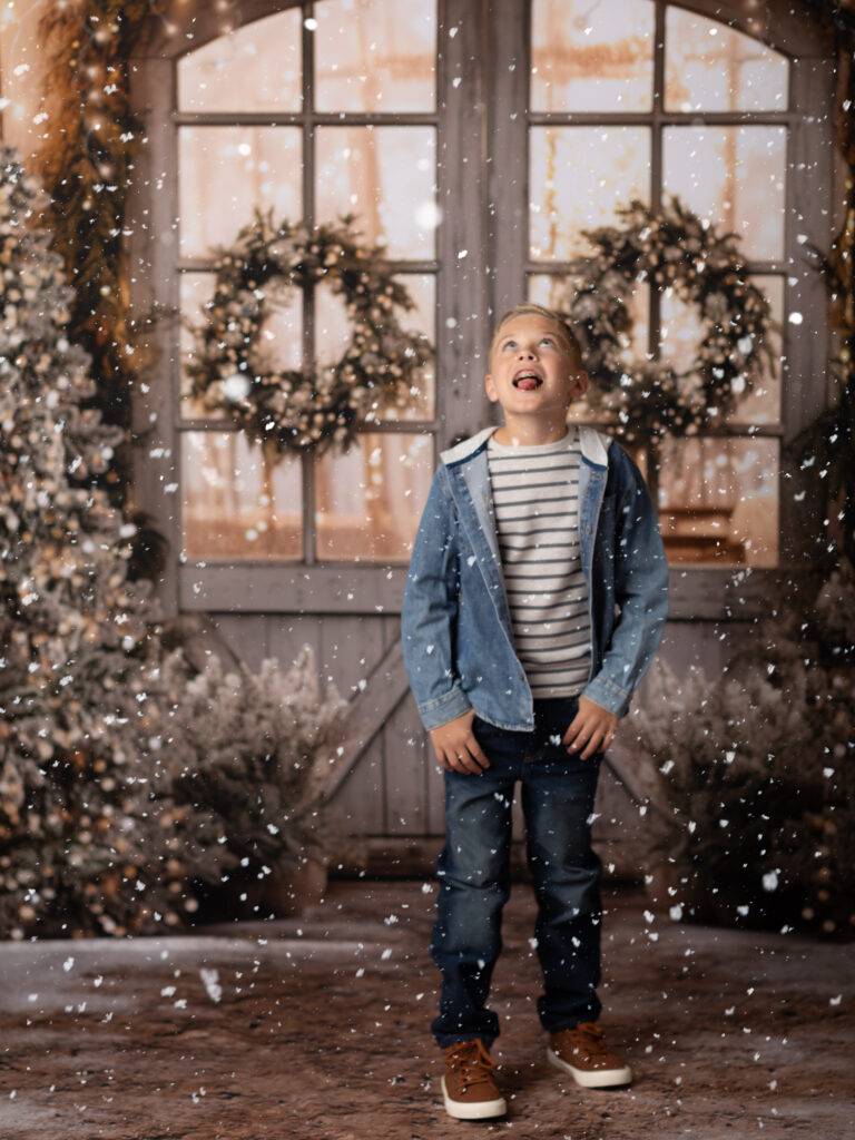 boy in jean jacket posed for Christmas portraits Christmas photography sessions in Cleveland