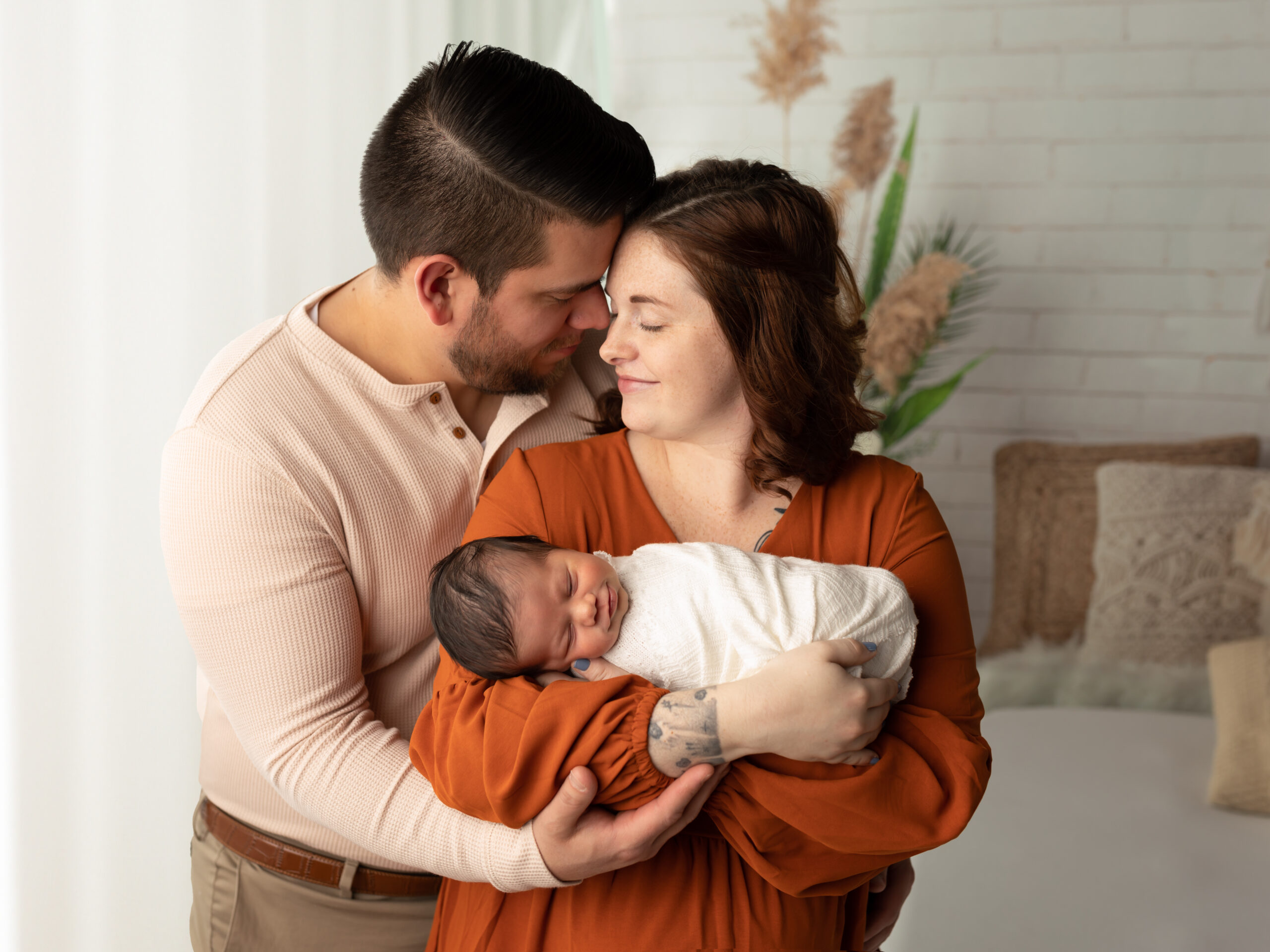 husband and wife holding newborn baby boy akron ohio newborn photographer