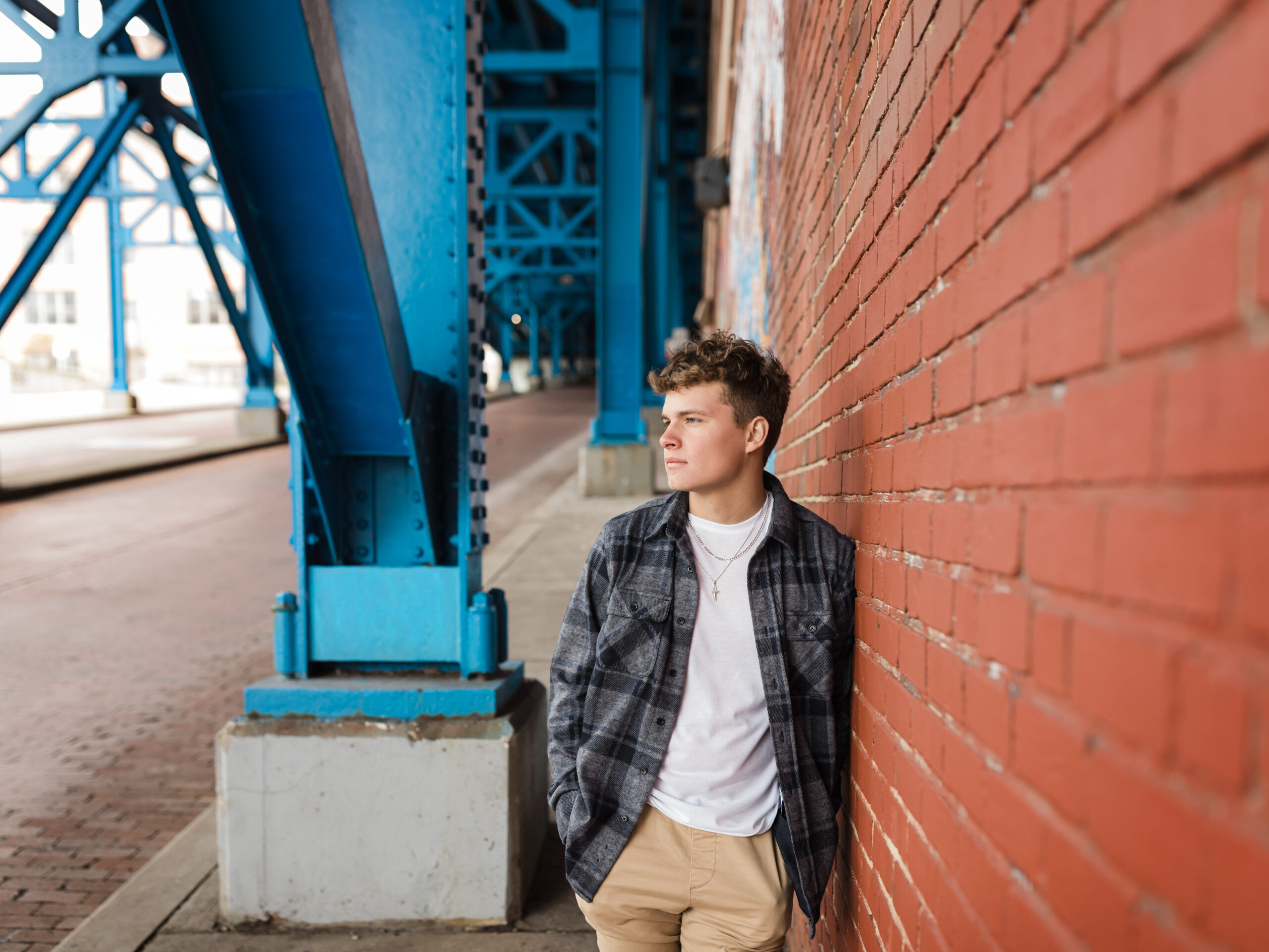 male senior standing against brick wall for portratits senior photography cleveland ohio