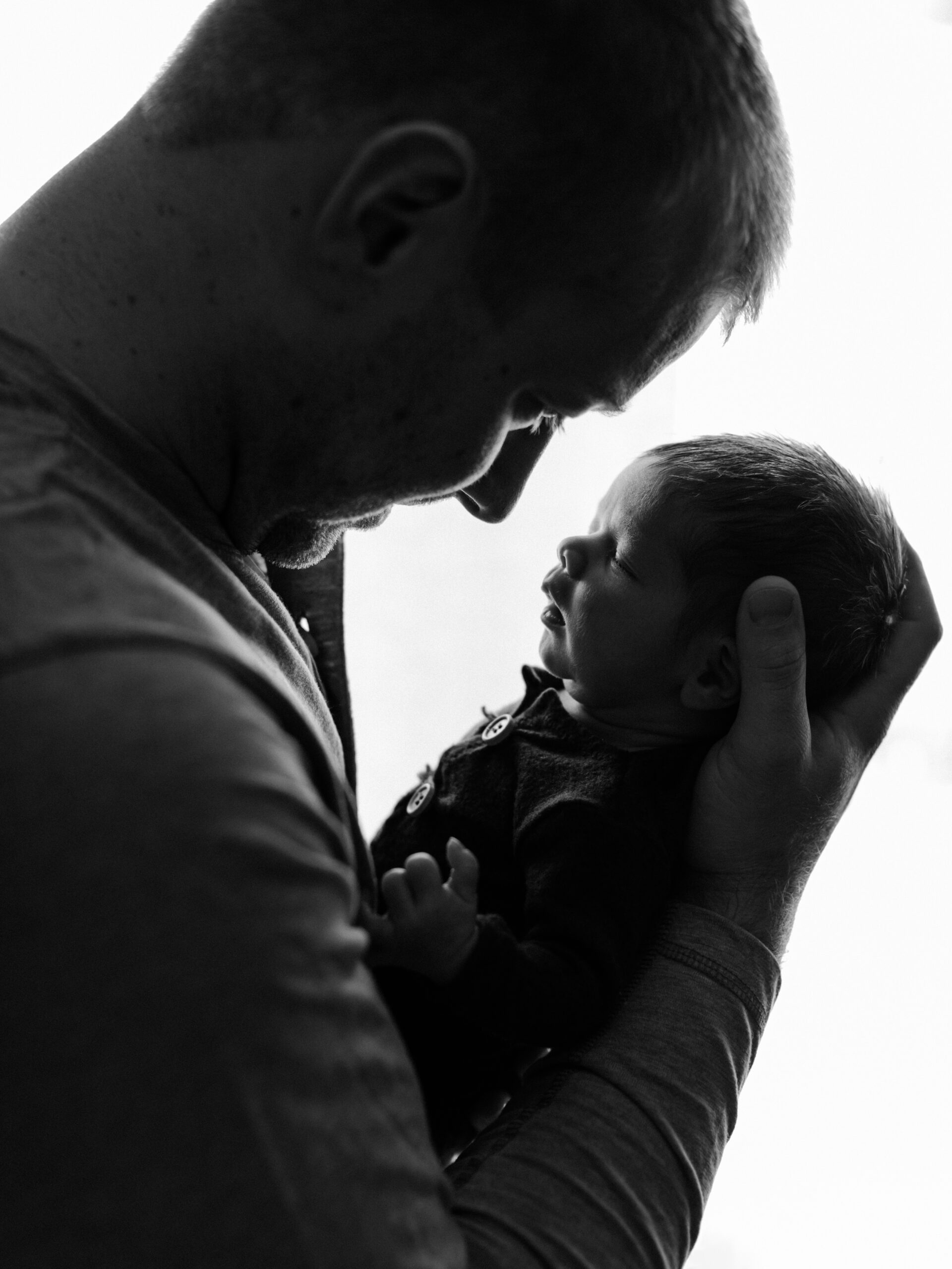 dad holding newborn baby boy for in home session Southwest general medical group