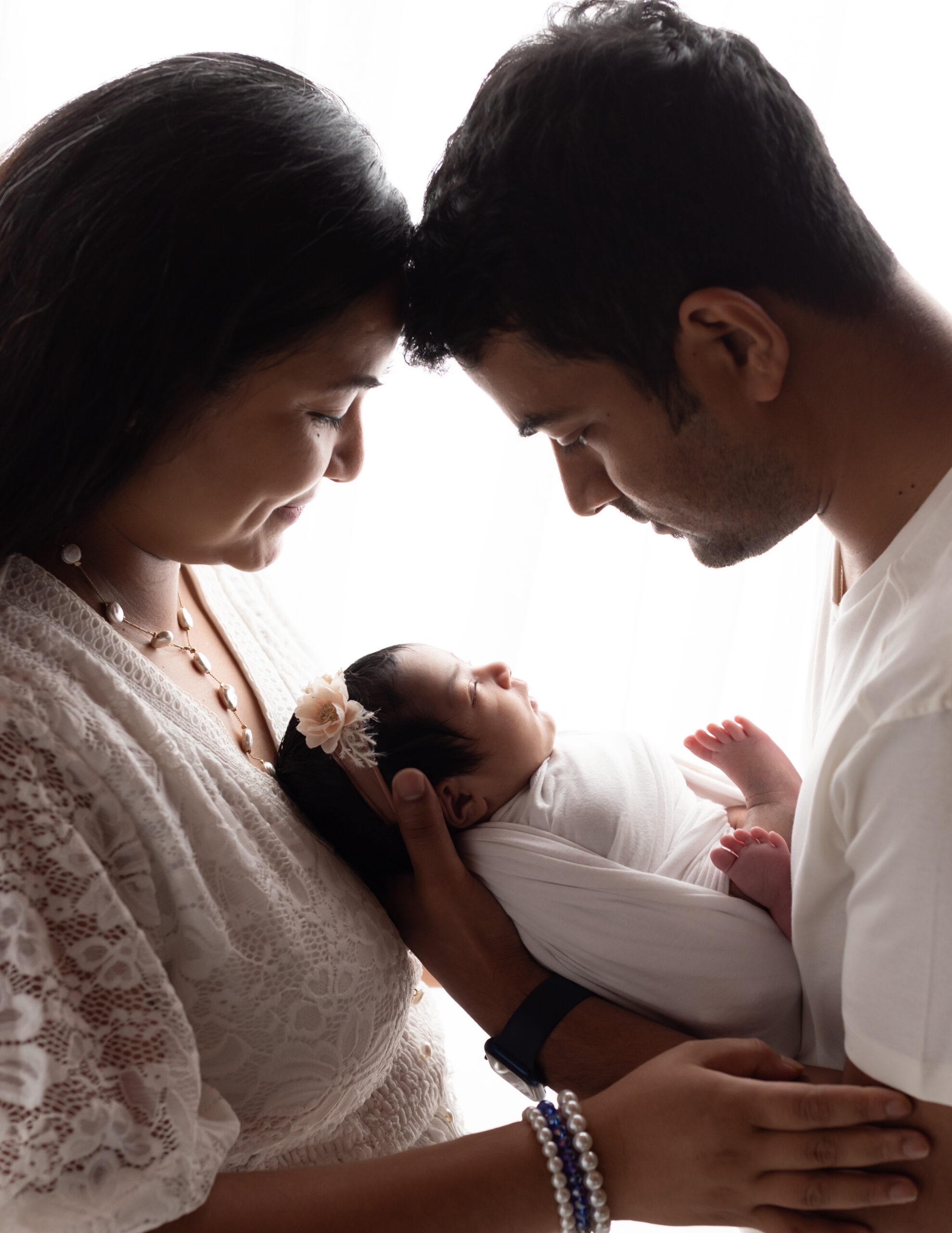 Mom and dad holding newborn baby girl for studio photoshoot Medina Photographer