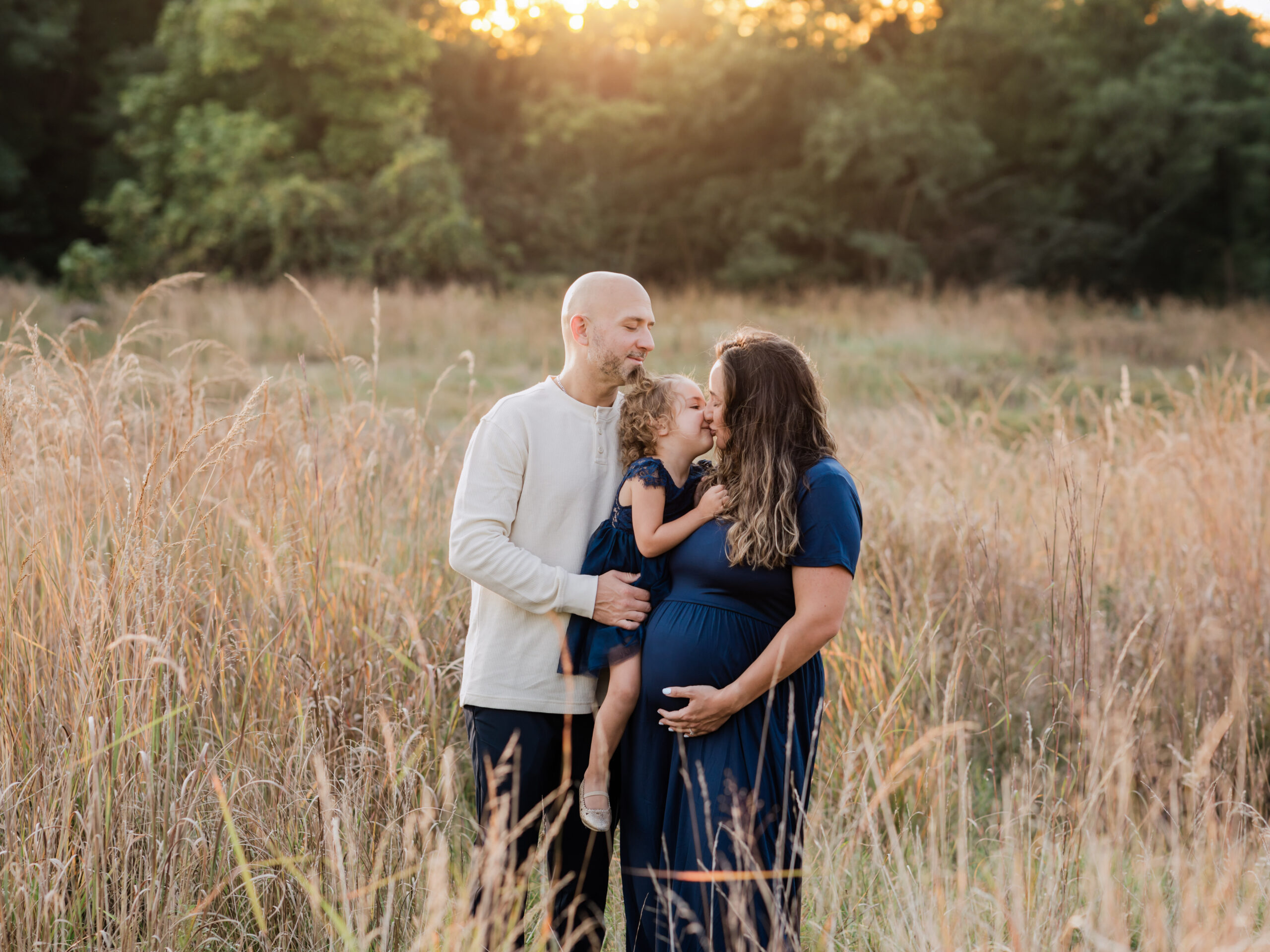 father and pregnant mother with daughter hugging for maternity photoshoot Ohio Maternity Photographer