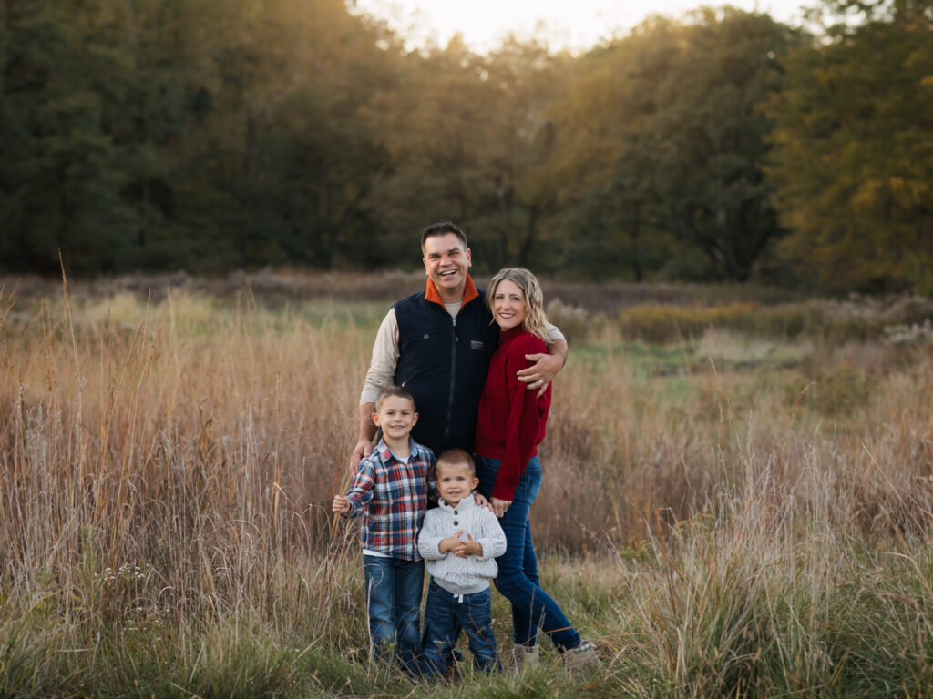 parents and two sons posing fall family photos in park Family Friendly Restaurants in Cleveland