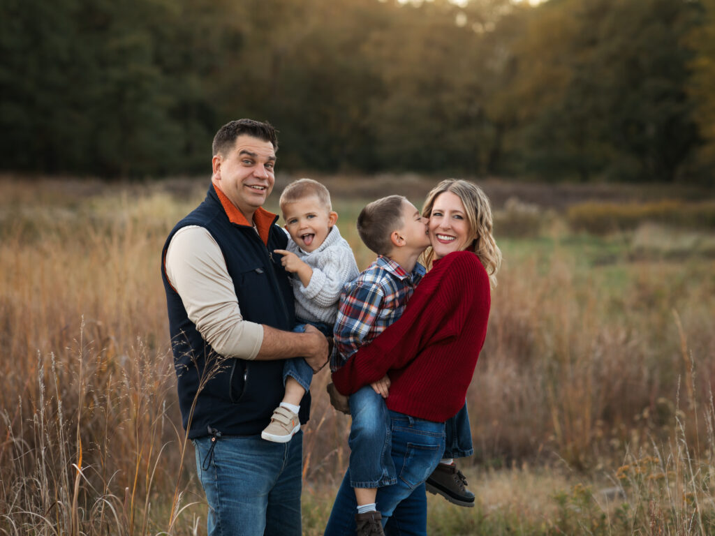 parents holding two sons for fall family photos in park Family Friendly Restaurants in Cleveland