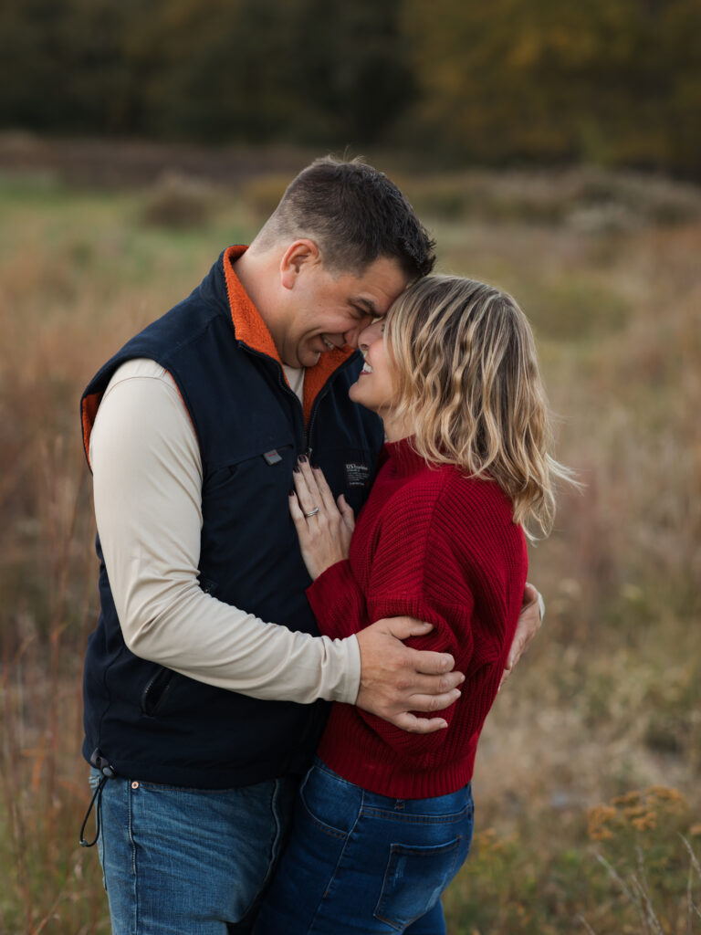 husband and wife hugging for family photos