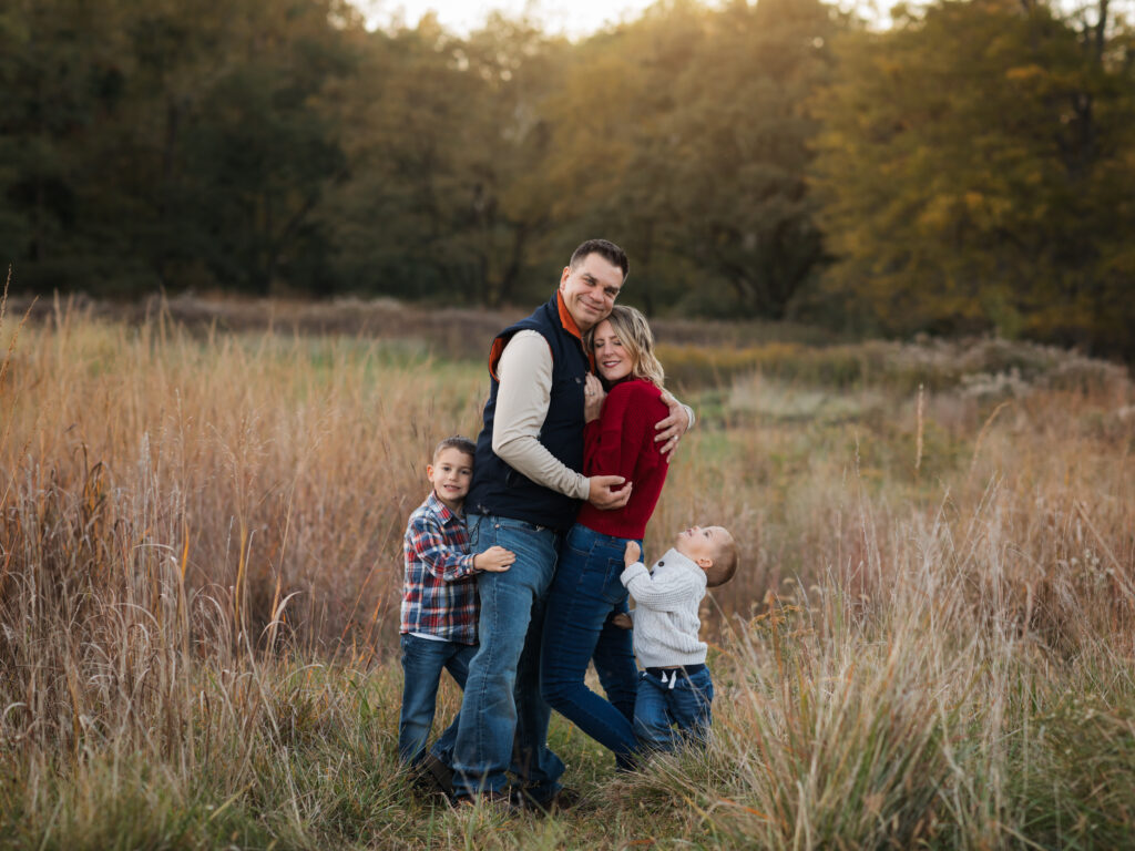 parents and two sons posing fall family photos in park Family Friendly Restaurants in Cleveland