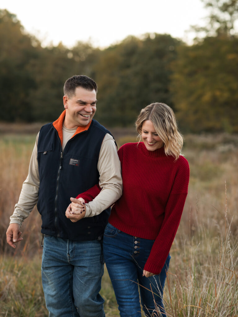 husband and wife holding hands for fall family photos