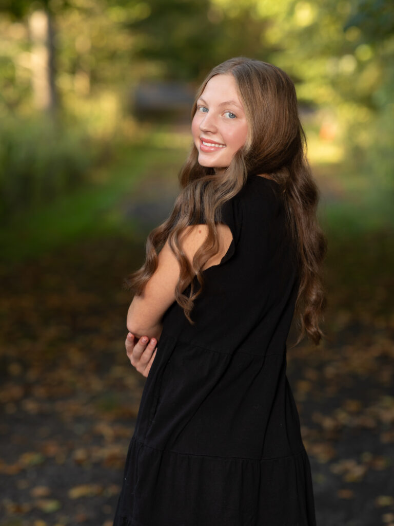 girl in black dress posed for family photos