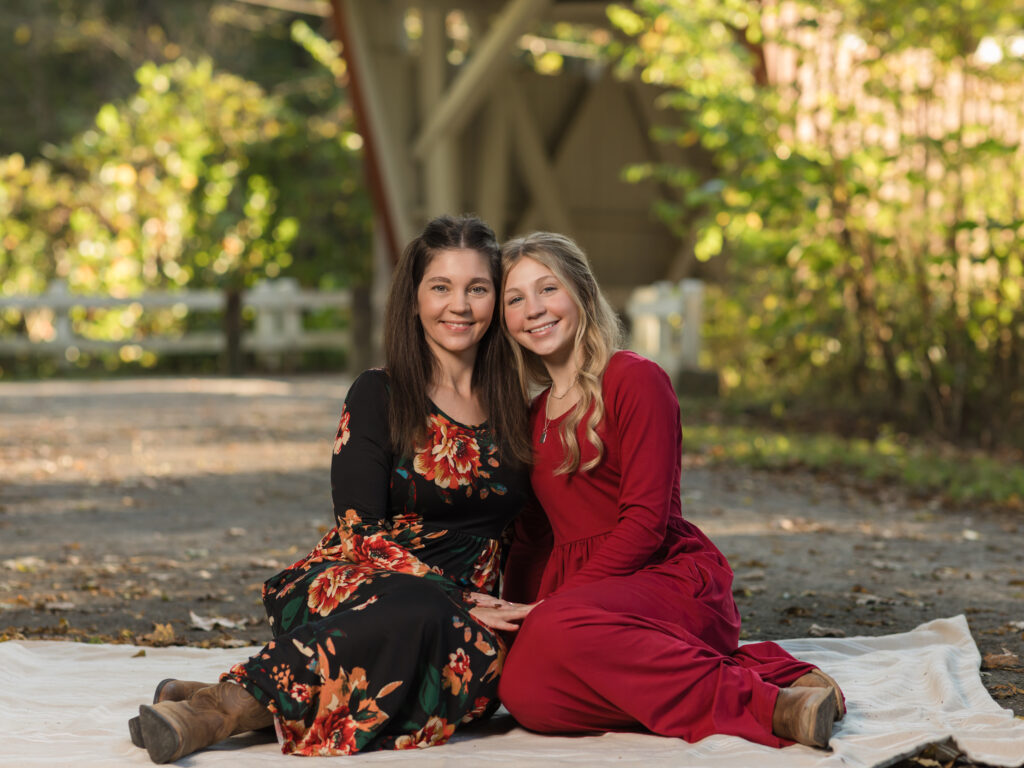 mother and daughter sitting on blanket for fall family photos