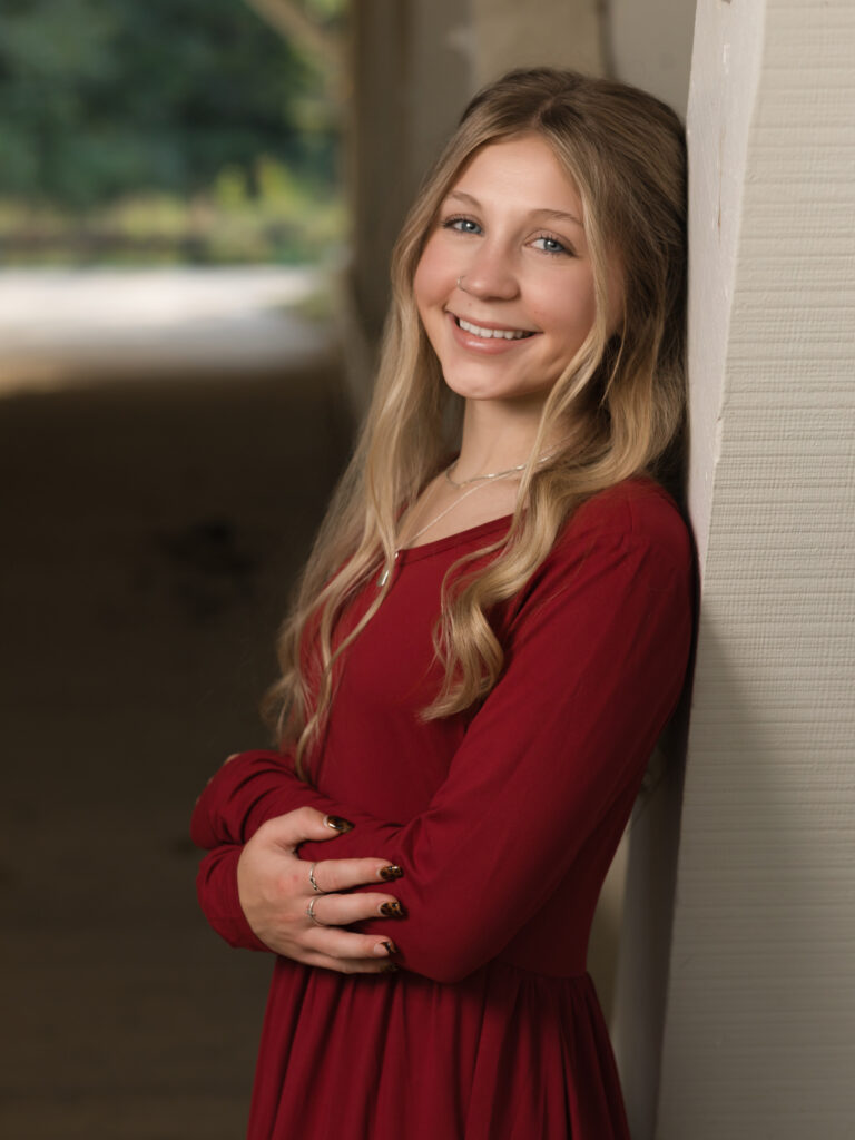 girl in red dress posed for family photos 