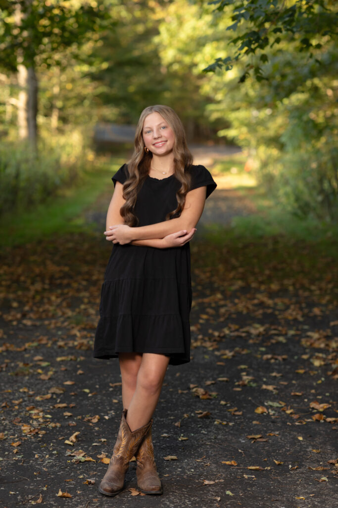 girl in black dress posing in park for fall family photos Everett Covered Bridge in Peninsula