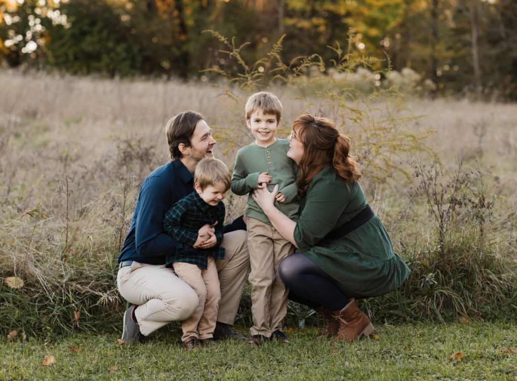 parents hugging two sons for fall family photos Allardale Park Medina