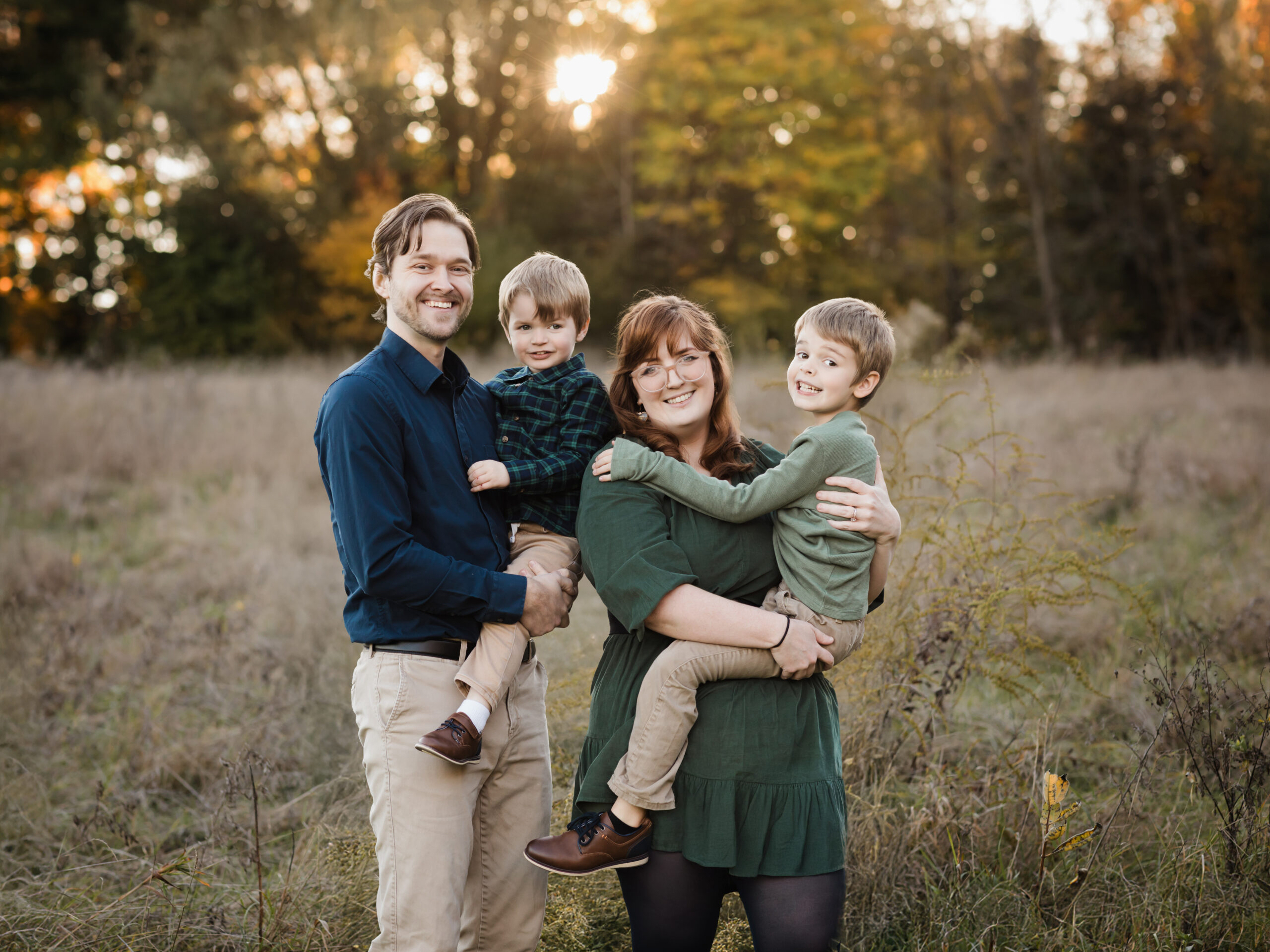parents holding two sons for fall family photos Allardale Park Medina