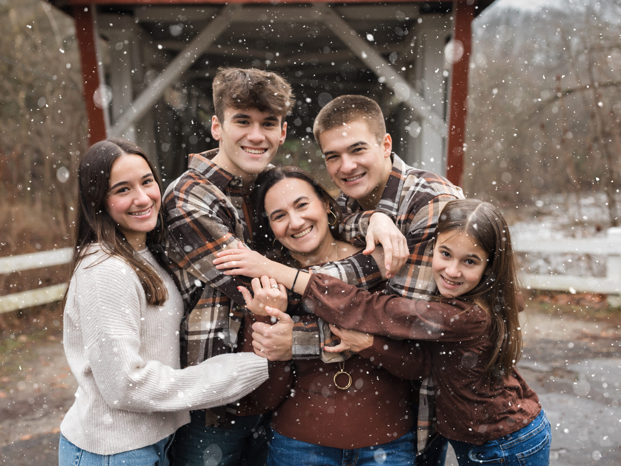 Mother and four children hugging for family photos Snow tubing in Cleveland Ohio