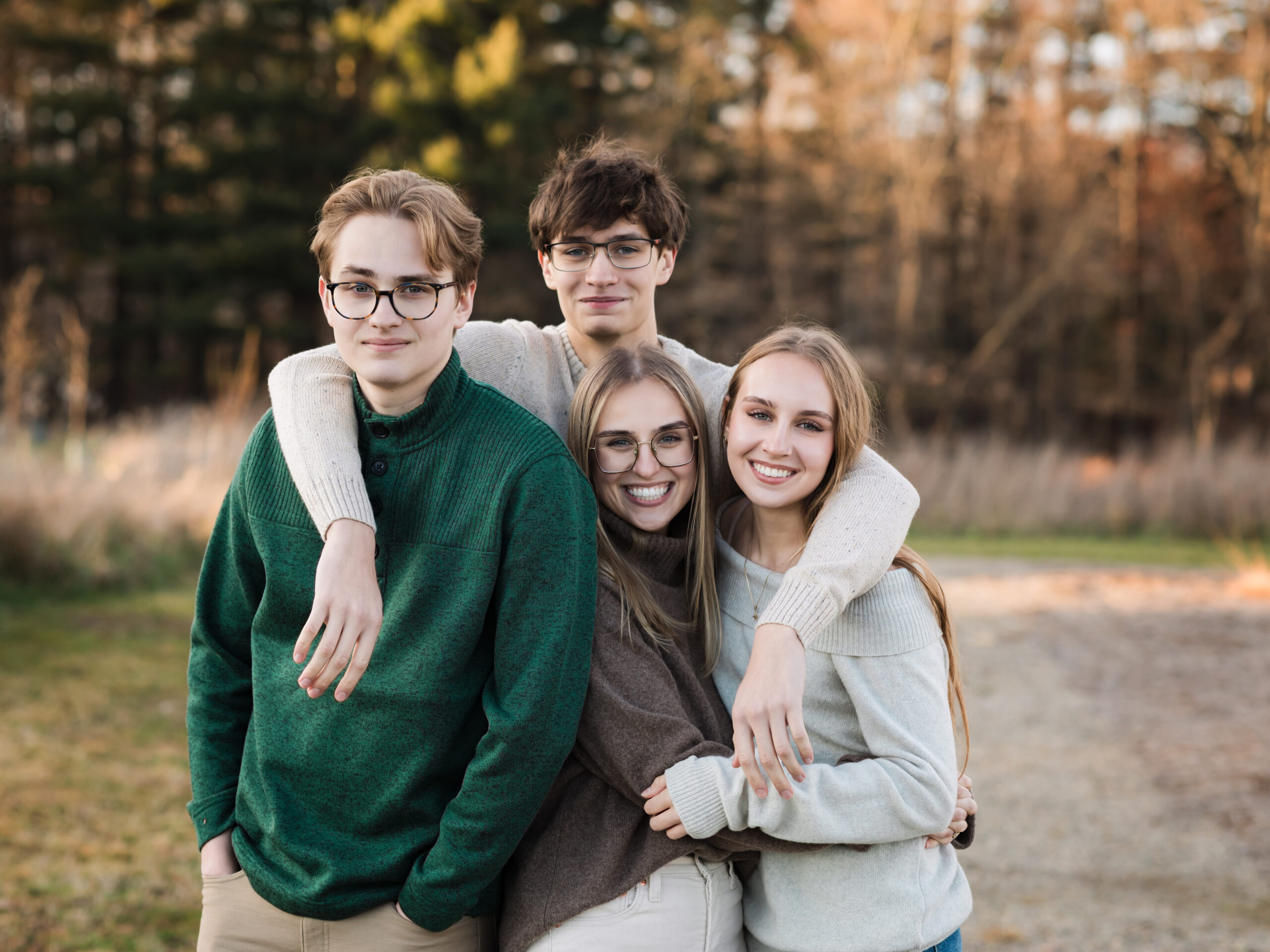 four siblings hugging for family photoshoot Winter Family Activities in Northeast Ohio
