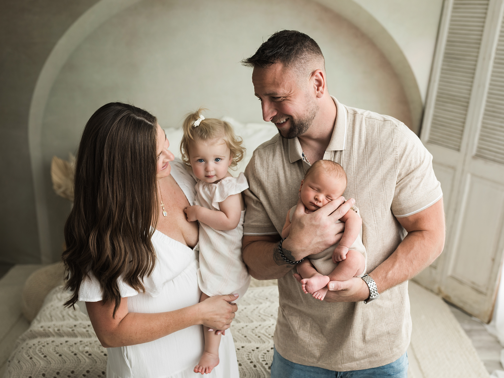 parents holding daughter and newborn son for family photoshoot Cleveland Water Parks